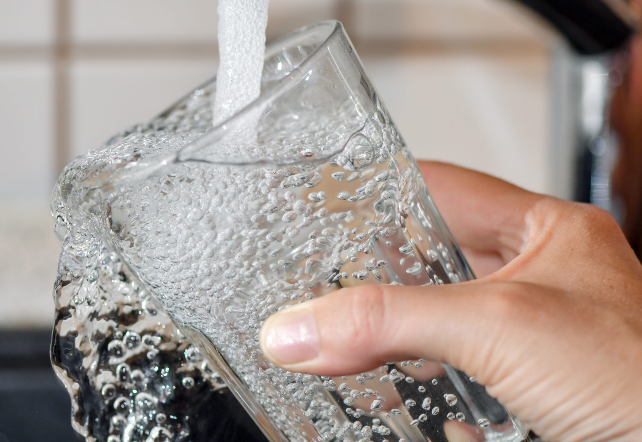 A drinking glass is filled with tap water in August 2019