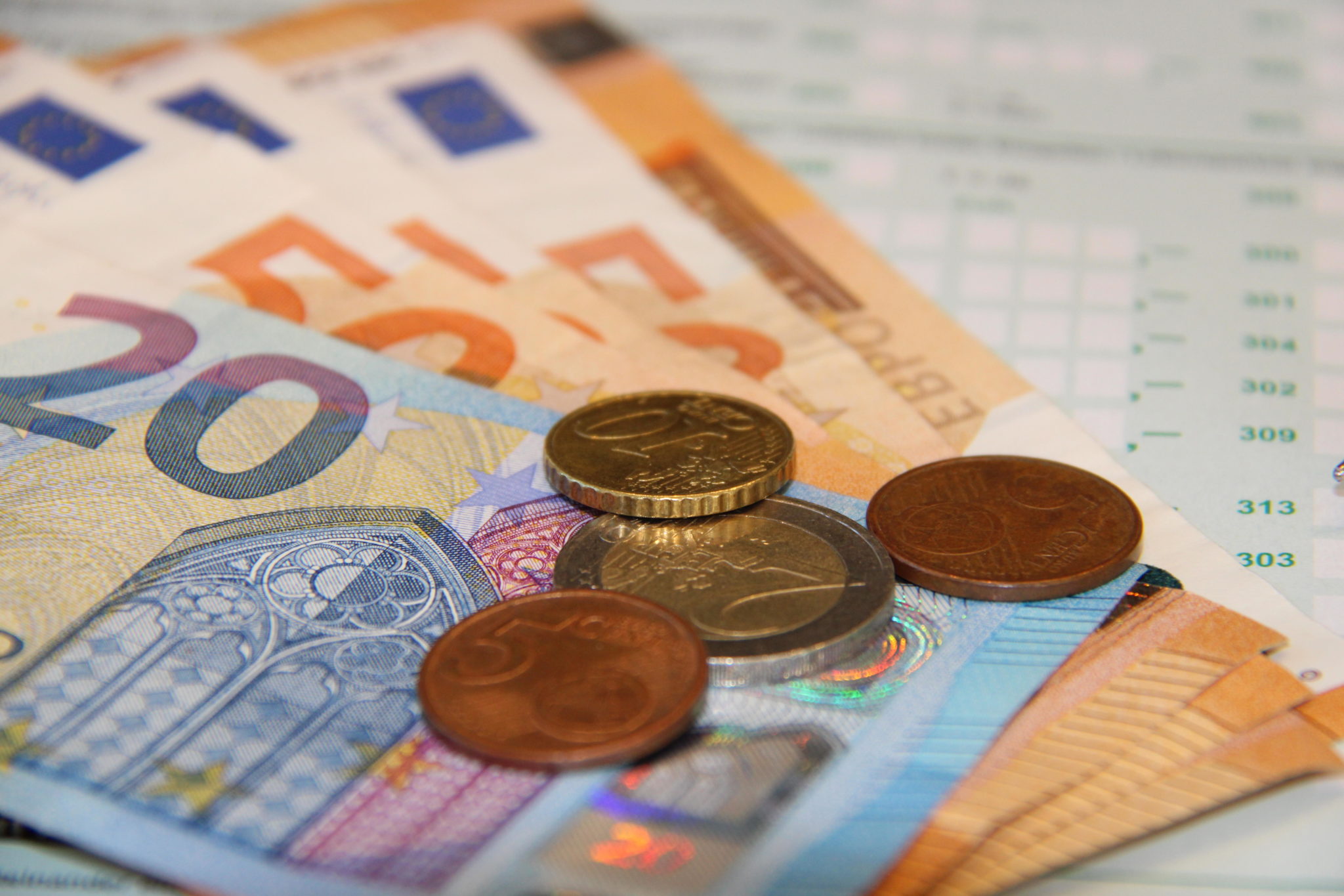 Euro notes and coins are seen beside a tax form in May 2018.