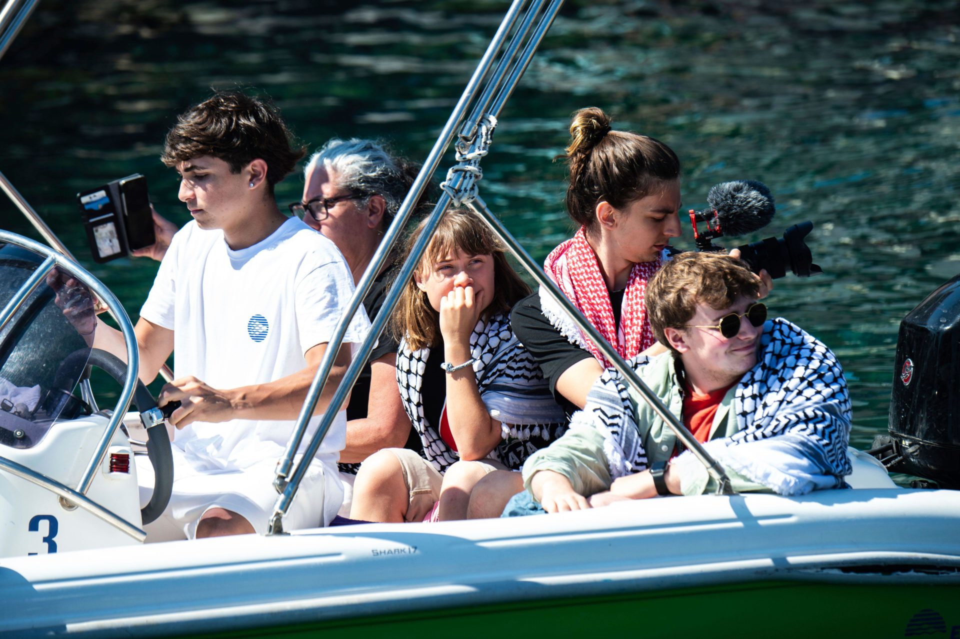 Climate activist Greta Thunberg, center, waits to board the Madleen boat, before setting sail for Gaza along with activists of the Freedom Flotilla Coalition, departing from the Sicilian port of Catania, Italy.